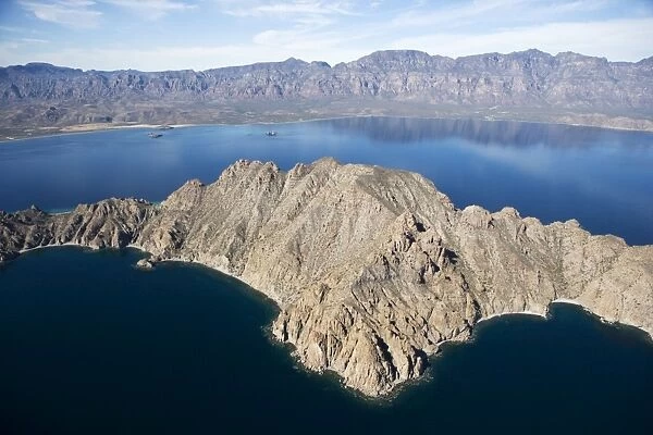 Baja California and Sea of Cortez, Mexico Aerial view of Danzante Island (foreground) and the Baja Peninsula, south of Loreto. The range in the background is known as Sierra de la Giganta