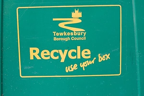 Close up of green recycle bin Cotswolds UK. Supplied with Tewkesbury Borough Council logo and use your box wording, for bottles and cans Cotswolds, UK