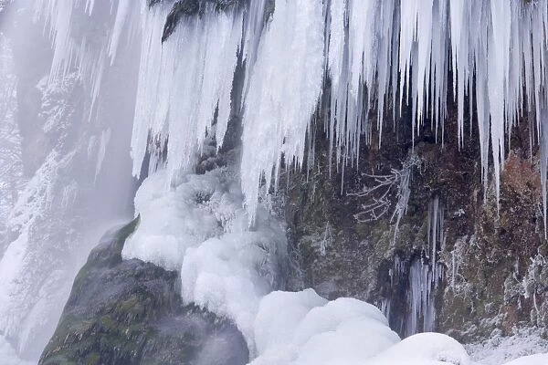 Frozen Waterfall - a waterfall in winter with numerous icicles and snow and ice covered rocks and trees - Swabian Alb - Baden-Wuerttemberg - Germany