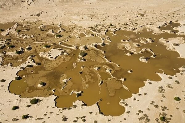 Water from recent rains accumulates in an excavation site where sand is dug up to supply the building trade - Namib Desert - Namibia - Africa