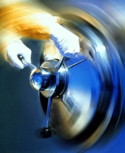 Autoclave oven. Time-exposure image of gloved hands opening an autoclave oven