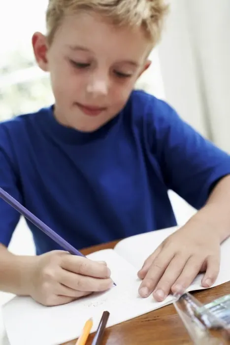 Framed Print : Boy drawing in an exercise book Print Framed Print : Boy drawing in an exercise book Print