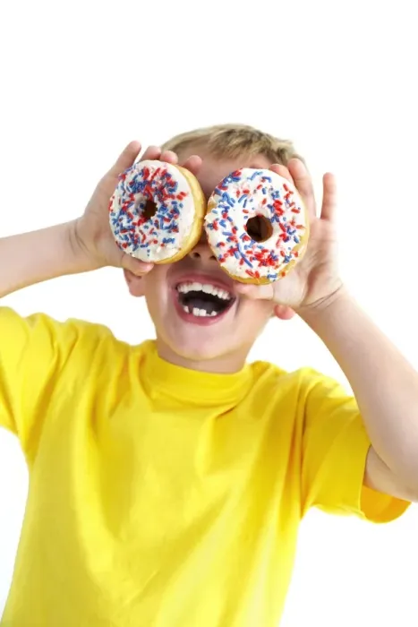 Framed Print : Boy playing with doughnuts Print Framed Print : Boy playing with doughnuts Print