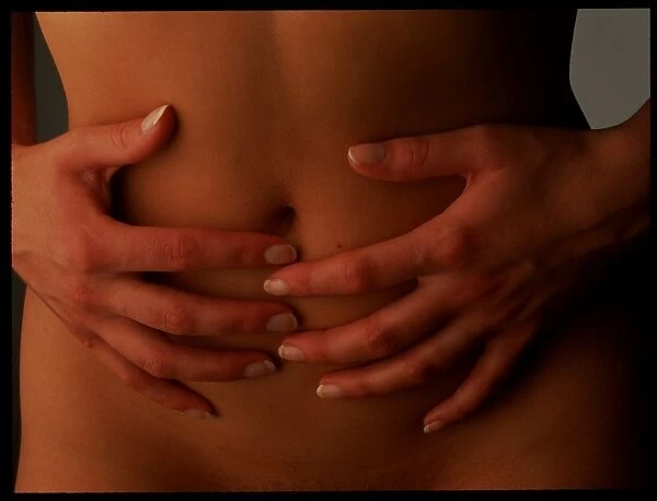 Menstrual pain: womans hands holding her abdomen