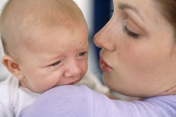 Mother comforts baby boy