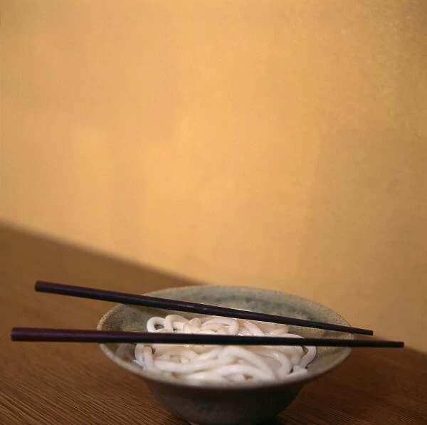 Noodles. Bowl full of noodles with a pair of chopsticks resting on top