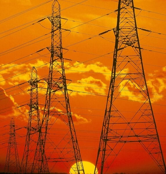 Pylons carrying electricity wires at sunset