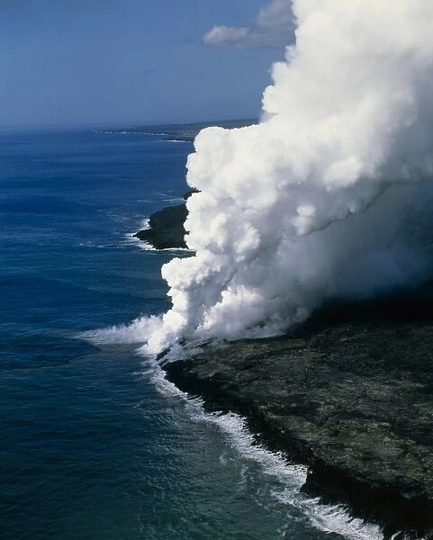 Steam rising as molten lava meets the ocean