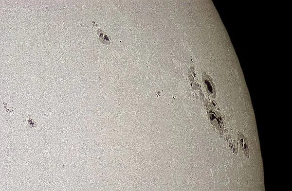 Sunspots on the surface of the Sun. These are cooler