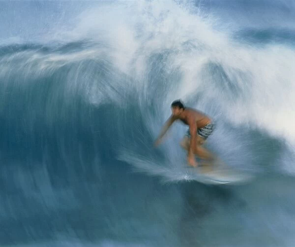 Surfer riding a breaking wave in Hawaii