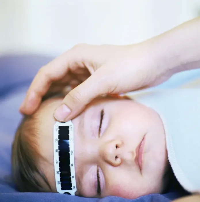 Framed Print : Baby's temperature measured with a strip thermometer Framed Print : Baby's temperature measured with a strip thermometer