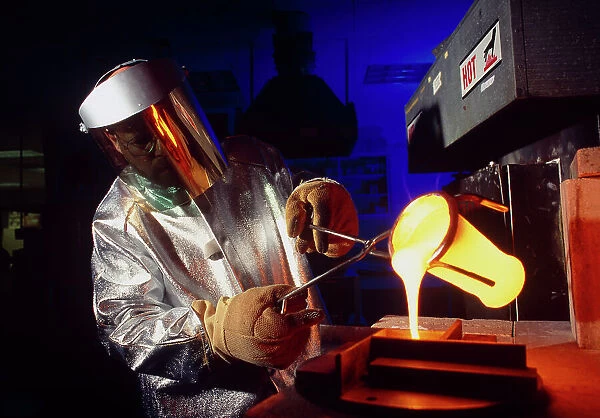 Technician pours molten glass from a crucible