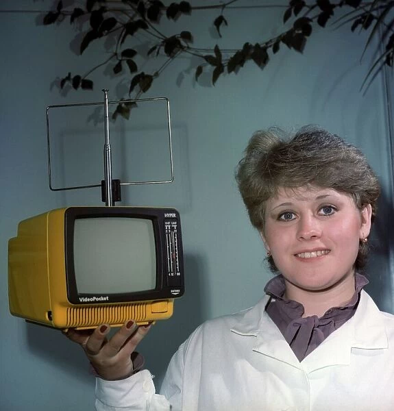 Woman holding a small television