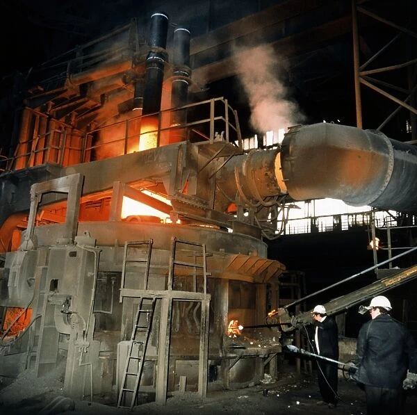 Workers attending to a blast furnace