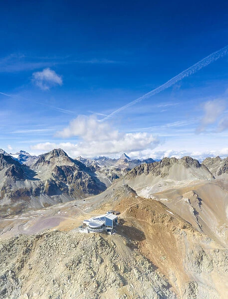 Aerial by drone of clear sky over Piz Nair and cable car station on top, Engadine