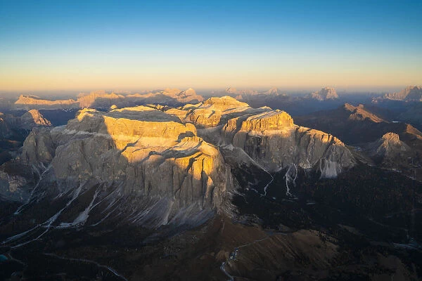 Aerial view of sunset over Sella Group and Sass Pordoi in autumn, Val Gardena