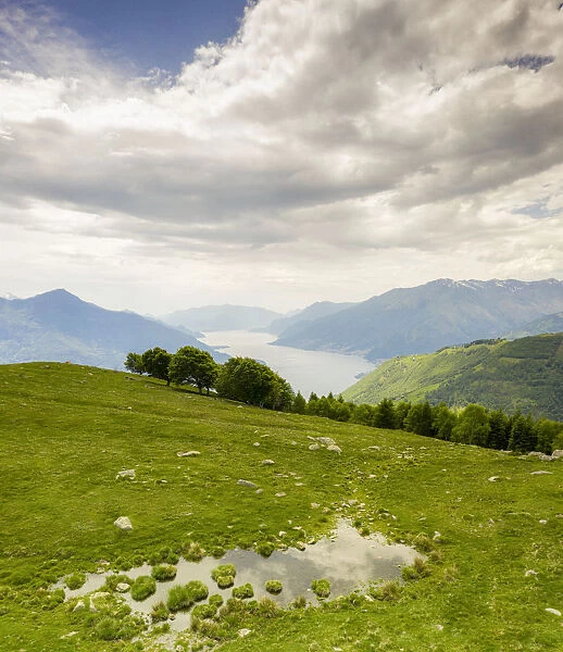 Alto Lario and Lake Como seen from green meadows of Montemezzo mountains, Lombardy