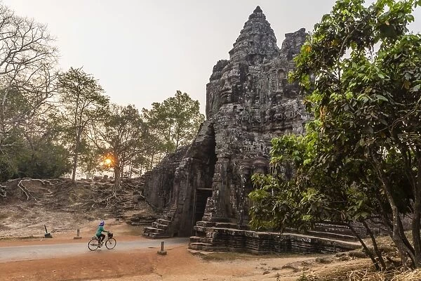 Bicycle going through the South Gate in Angkor Thom at sunrise, Angkor, UNESCO World Heritage Site, Siem Reap Province, Cambodia, Indochina, Southeast Asia, Asia