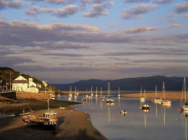 Boats in the evening sun at low tide on the Dovey Estuary
