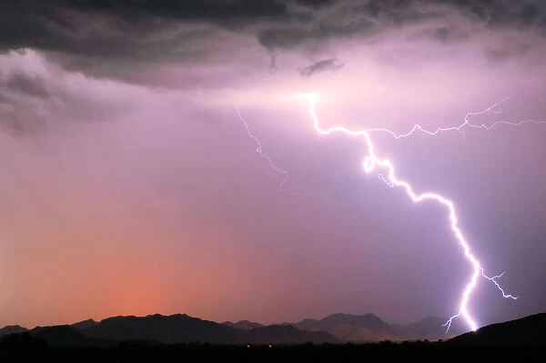 A bright lightning strike illuminating the Buckeye Foothills in Arlington during