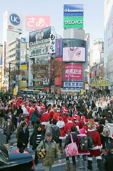 Christmas Santas walking across Shibuya crossing, Shibuya ward, Tokyo, Japan, Asia