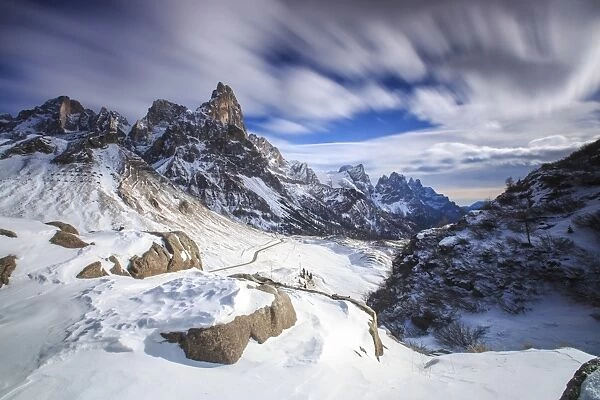 Cloudy winter sky on the snowy peaks of the Pale di San Martino, Rolle Pass, Panaveggio
