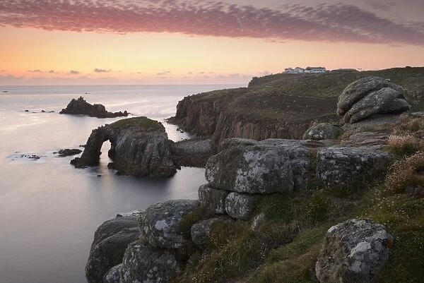 A colourful sunset overlooking the islands of Enys Dodnan and the Armed Knight at Lands End