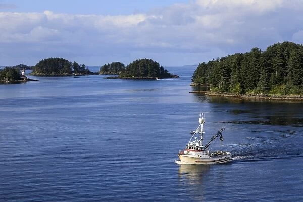 Commercial fishing boat and small forested islands, rare summer sun, Sitka Sound