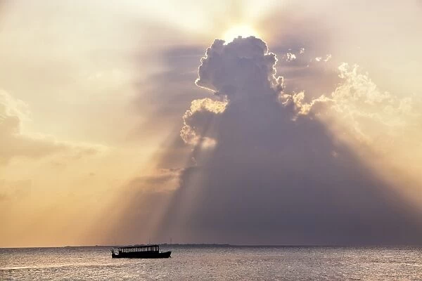 Dramatic cloud formations and boat in silhoutte at sunset, Dhuni Kolhu, Baa Atoll