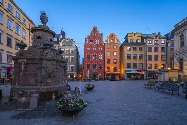 Dusk over the colorful facades of townhouses in the medieval Stortorget Square, Gamla