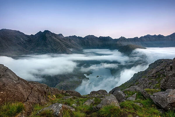 Early morning clouds drifting over the hills flowing down to Loch Coruisk below with