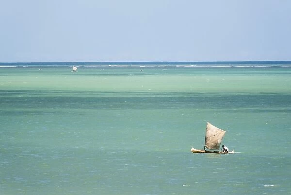 Fisherman fishing from a Pirogue, a traditional Madagascar sailing boat, Ifaty, Madagascar