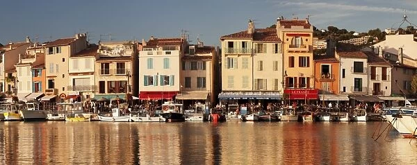 Fishing boats at the harbour, restautants and street cafes on the promenade, Cassis