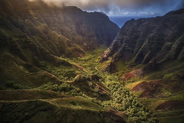 Flying through Nu alolo Valley via helicopter in the evening on the NaPali Coastline