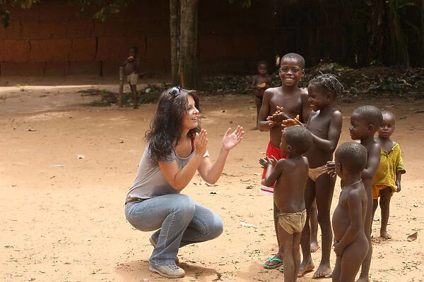 French woman playing wih African children, Tori, Benin, West Africa, Africa