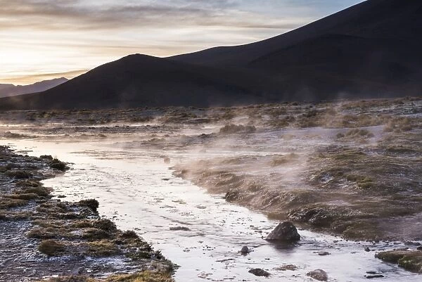 Geothermal river at sunrise at Chalviri Salt Flats (Salar de Chalviri), Altiplano of Bolivia
