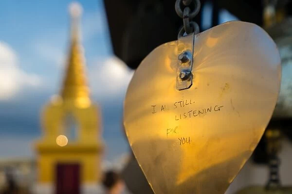 Golden prayer flag etching with Buddhist gold stupa in background, Bangkok, Thailand