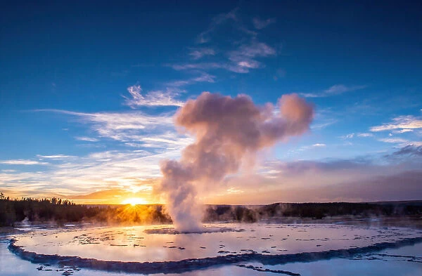 Great Fountain Geyser at sunset with reflection and sunburst, Yellowstone National Park
