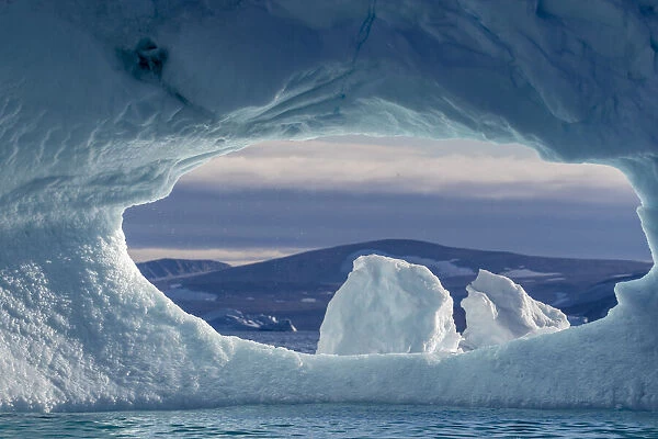 A hole in an iceberg in De Dodes Fjord (Fjord of the Dead), Baffin Bay, Greenland