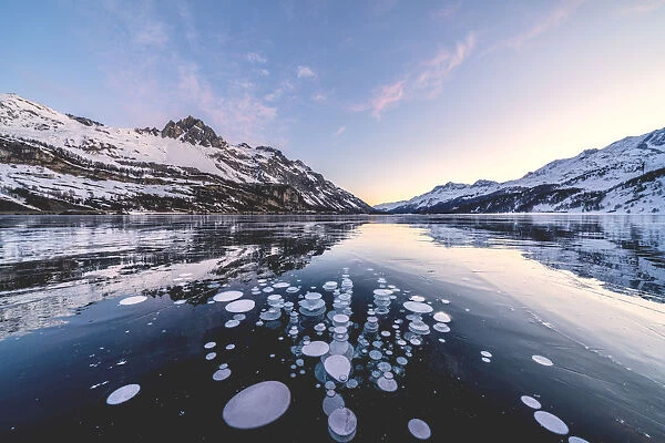 Ice bubbles trapped in Lake Sils with Piz Lagrev in background, Engadine