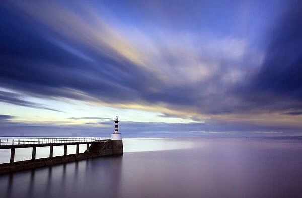 Long exposure image of Amble Lighthouse with streaky clouds and smooth sea, Amble