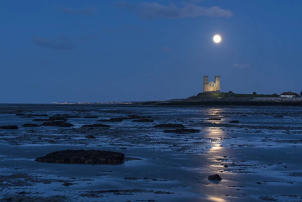 Full moon rising over Reculver Towers, beach at low tide, Reculver, Herne Bay, Kent