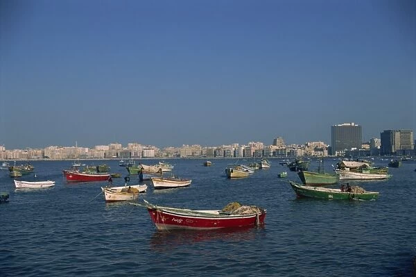 Moored boats before city skyline, Alexandria, Egypt, North Africa, Africa