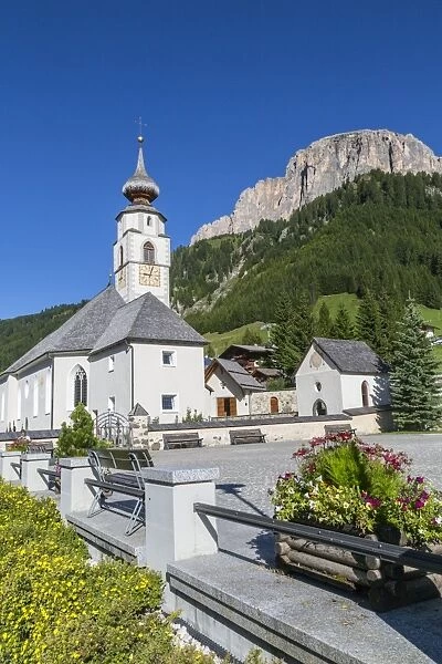 Morning view of Colfosco (Calfosch) Church and surrounding mountains, Belluno Province