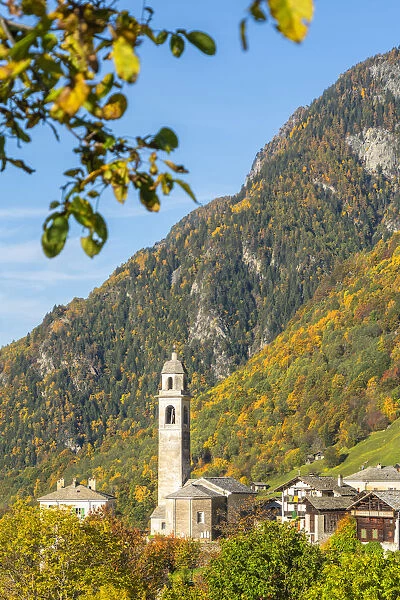 Old bell tower and church in the autumnal landscape, Soglio, Val Bregaglia