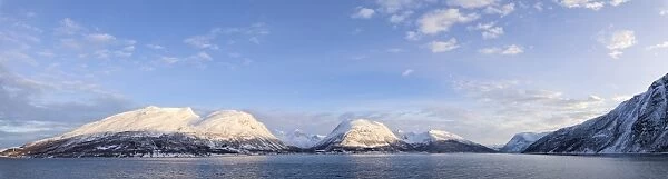 Panorama of snowy peaks surrounded by frozen sea, Olderdalen, Kafjorden, Lyngen Alps