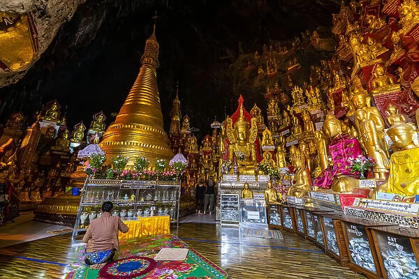 Pilgrims at the gilded Buddha images in the caves at Pindaya, Shan state, Myanmar (Burma)