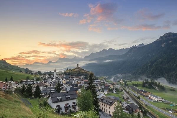 Pink clouds at dawn on the alpine village of Ardez, canton of Graub?nden, district of Inn