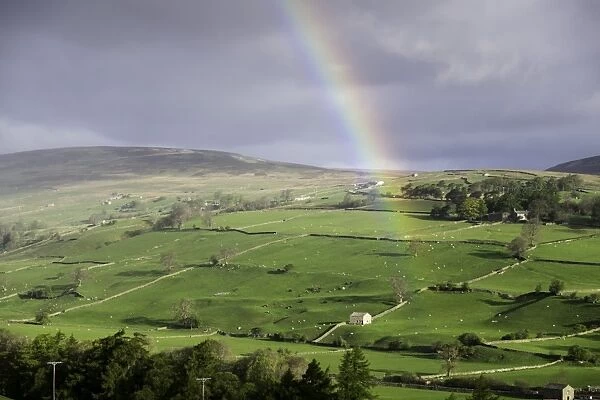 A rainbow over the countryside of Swaledale, Yorkshire Dales, Yorkshire, United Kingdom
