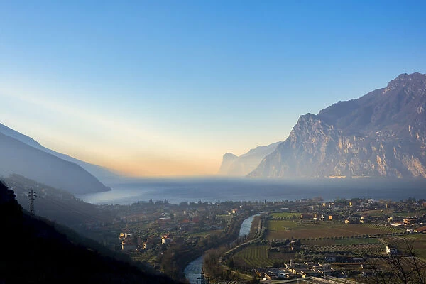 Riva del Garda at sunrise in winter, Lake Garda, Trentino, Dolomites, Italy, Europe